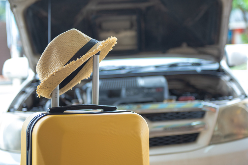 Suitcase with hat and car, Preparing or Check Your Car Before a Road Trips