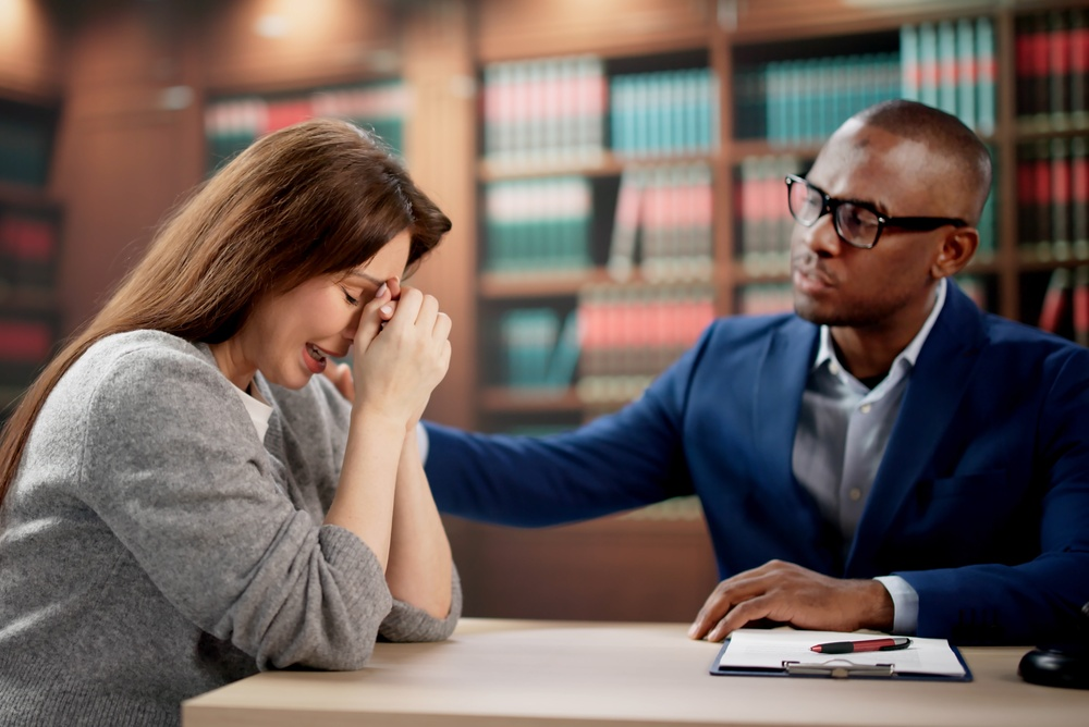 Young Woman Discusses Legal Claim With Attorney During Wrongful Death Consultation Session. Female Client Meets Lawyer